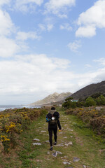 Obraz premium a backpacker doing hiking along a green path admiring the landscape