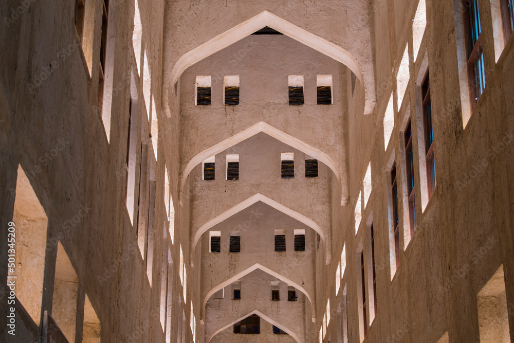 Wall mural doha, qatar, april 22,2022: night views of the traditional arabic architecture of souq waqif market.