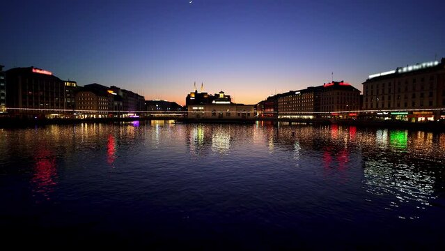 Geneva city at night with lights reflecting in Lake Geneva. Switzerland