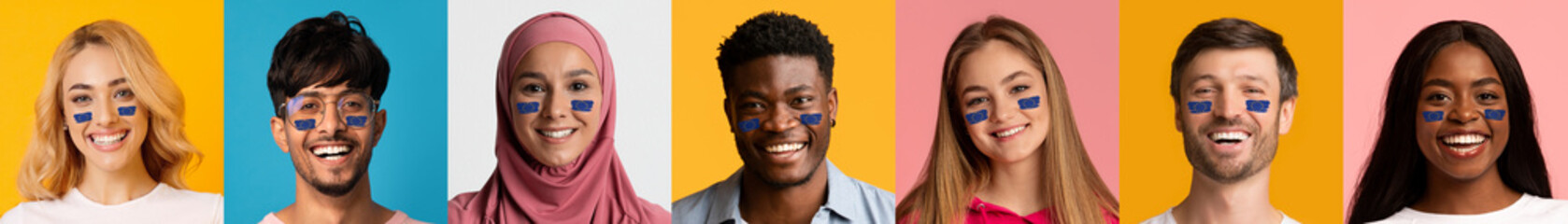 Happy multiethnic people with painted flag of EU on cheeks