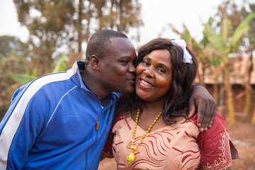 Son gives a kiss on the cheek of mother, African mother and son, concept of mother's day