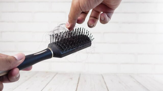 man hold his list hair close up 