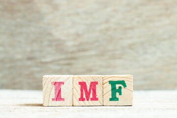 Alphabet letter block in word IMF (abbreviation of International Monetary Fund) on wood background