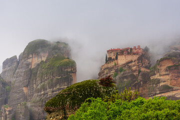 Meteora in Greece, monastery on the background of mountains, cloudy sky
