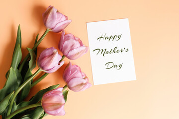 Postcard with text Happy Mother's Day and tulips on a yellow background. Mother's day greeting card...