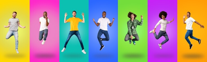 Carefree millennial guys of different races jumping up
