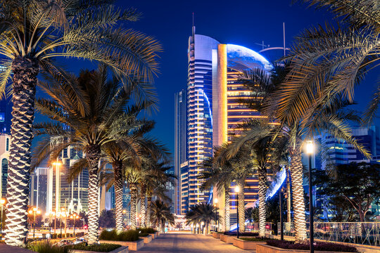 Doha, Qatar - Apr. 2020: Night view in the city center of Doha, Qatar with many modern luxury buildings and skyscrapers illuminated with numerous lights.