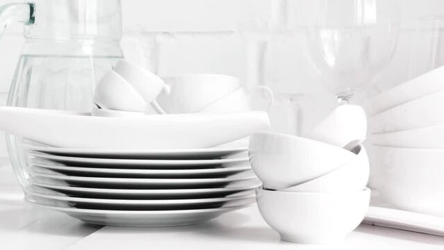 White porcelain dishes on table. Slow pan.