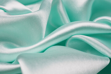 Smooth elegant green silk or satin texture can use as background for design, beautiful of fabric