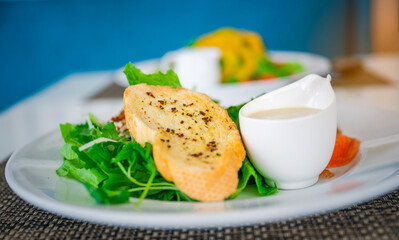 Salad with Crispy garlic bread-Italian and salad dressing, side view, selective focus.