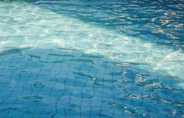 Swimming pool floor with water ripple. Blue texture background.