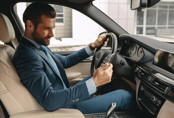 Adorable confident man in formal wear reading message on cell phone in car
