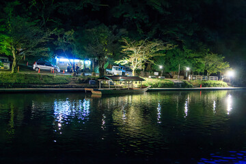 Fototapeta premium Empty tourist ferry boat docked along river at night