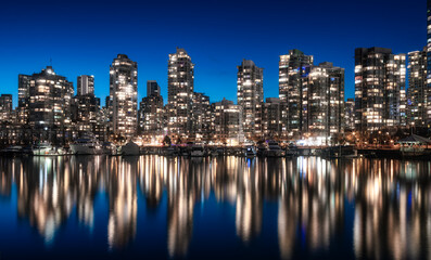 Fototapeta premium False Creek with modern city buildings at night after sunset. Downtown Vancouver Cityscape, British Columbia, Canada. Panorama