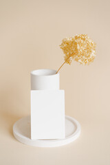 Vertical card mock up minimalist branding concept. Terrazzo plate on beige background, terrazzo vase with dry yellow flowers. Instagram mock up