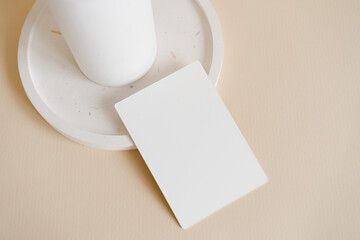 Obraz na płótnie Canvas Minimalist menu mock up card on the terrazzo plate on beige background. Vertical modern business card template 