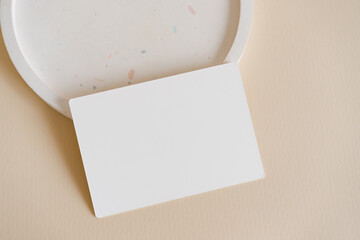 Minimalist menu mock up card on the terrazzo plate on beige background. Modern template 