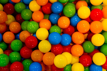 Fototapeta na wymiar Colorful plastic balls used in a playing bin or pit, also known as a ball ocean. Close up.