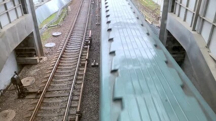 The subway train travels on the elevated track.