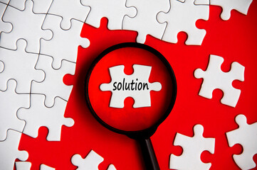 Solution text on missing jigsaw puzzle in magnifying glass.