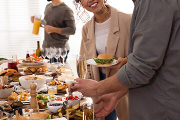 Couple enjoying brunch buffet together indoors, closeup