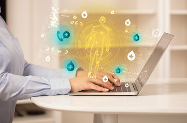 Doctor working on laptop with healthcare concept