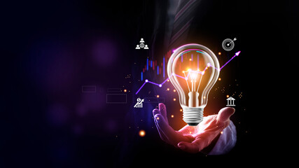 Businessman holding a bright light bulb on neon purple background. Concept of Ideas for presenting...