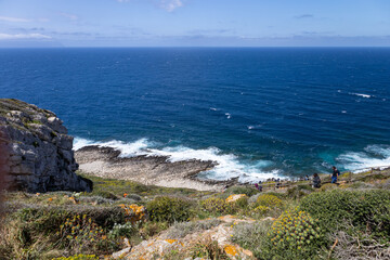 Fototapeta premium hikers walk towards Cala Genovese on the island of Levanzo. (Egadi) Aegadian Islands, Trapani, Sicily, Italy