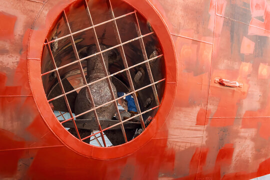 Close Up View Of A Ship Yard Worker Inside Big Ship Thruster Tunnel Inspecting Bow Thruster