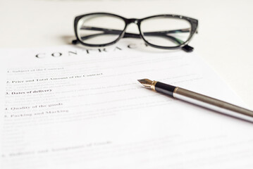 Close up of a job application form on desk with pen and glasses