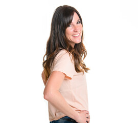 Fototapeta premium Happy carefree woman with joyful expression, smiling while standing in relaxed pose against white background