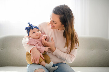 Mother with her baby son on sofa