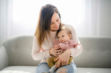 Mother with her baby son on sofa