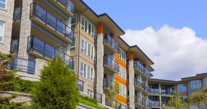 Establishing shot of modern apartment building with beautiful spring blossom landscape in Vancouver, Canada, North America. Day time on April 2022. ProRes 422 HQ.