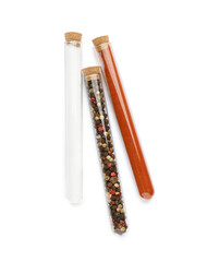 Glass tubes with different spices on white background, top view
