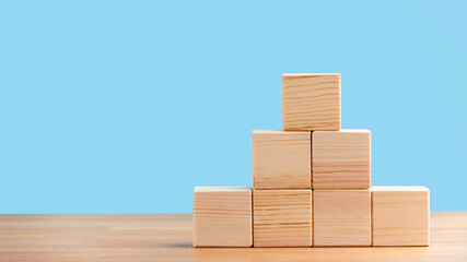 Blank wooden block cubes on a blue background for your text. free space for business concept template and banner..