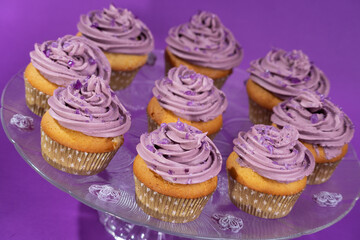 Cupcakes with violet scented swiss meringue buttercream decorated with pieces of violet candy
