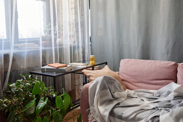 Horizontal no people shot of loft living room interior in modern apartment with sofa, desk and bottle of pills on it