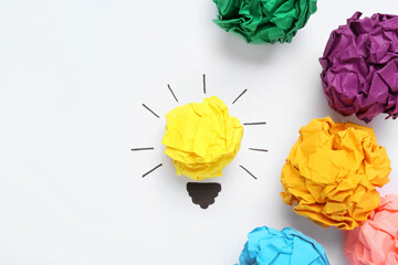 Flat lay composition with yellow crumpled paper ball as lamp bulb on white background, space for...