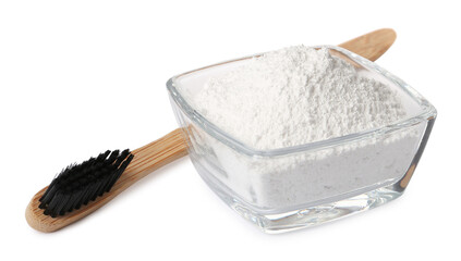 Glass bowl of tooth powder and brush on white background