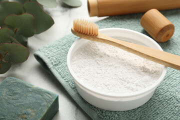 Fototapeta na wymiar Tooth powder, brush and soap on white table, closeup
