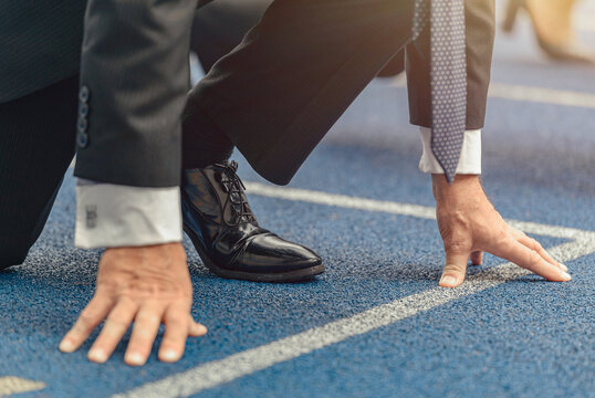 Close-up photo of businessman standing on race track