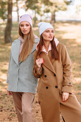 Two model girls showing fashionable outdoor sportswear on the street. Clothes from the showroom