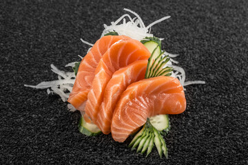Sushi with raw fish, Asian cuisine. Photo of food on a dark background.