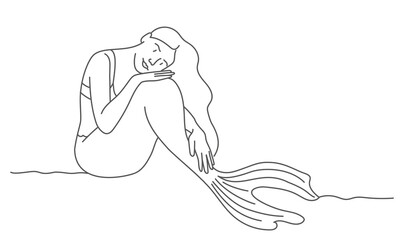 Pensive mermaid sits on the coast.