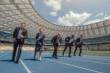 Multiracial business people running on sport track