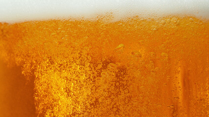 Macro photo of bubbling beer, closeup.