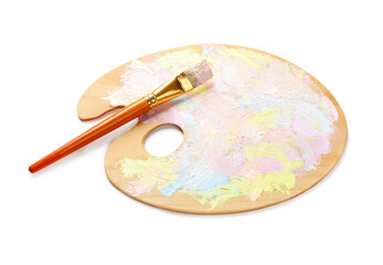 Wooden artist's palette with mixed pastel paints and brush isolated on white
