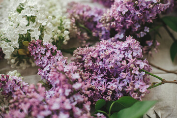Beautiful lilac flowers on linen fabric. Colorful purple and white lilac branches on rustic background. Spring countryside still life, floral image. Happy mothers day