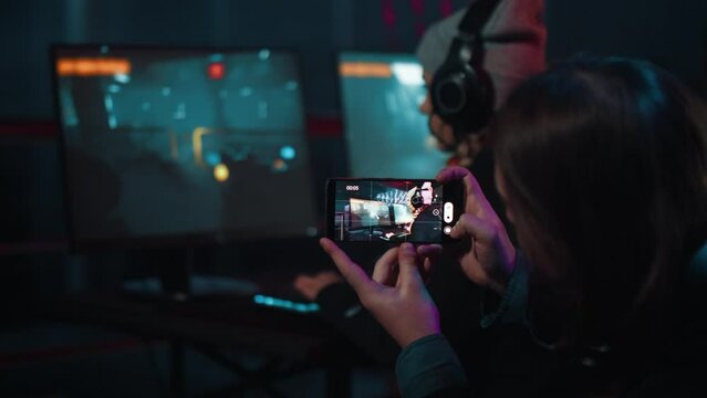 Teenager recording video of live professional esport player playing a game at the championship